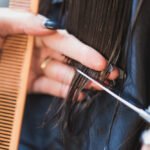 close-up-hands-trimming-hair